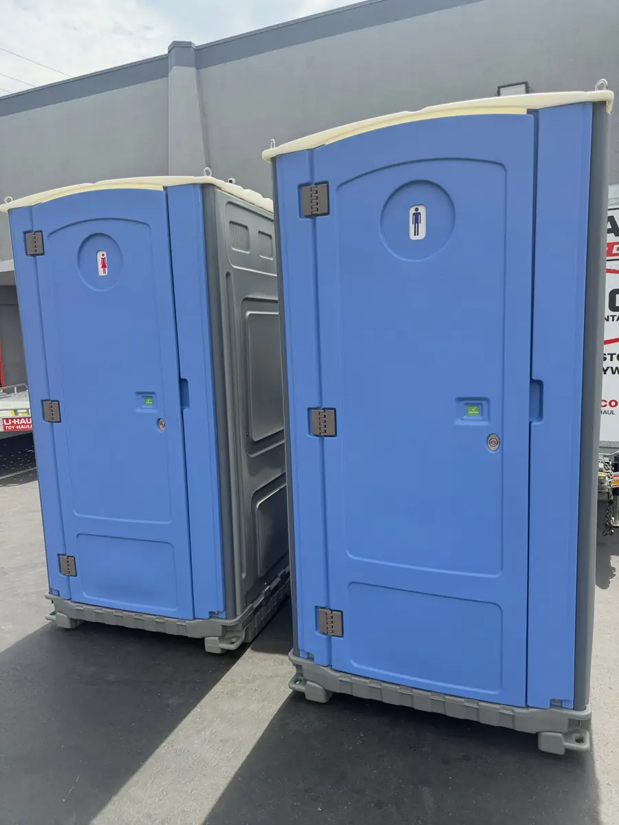 Two blue standard porta potties ready for delivery
